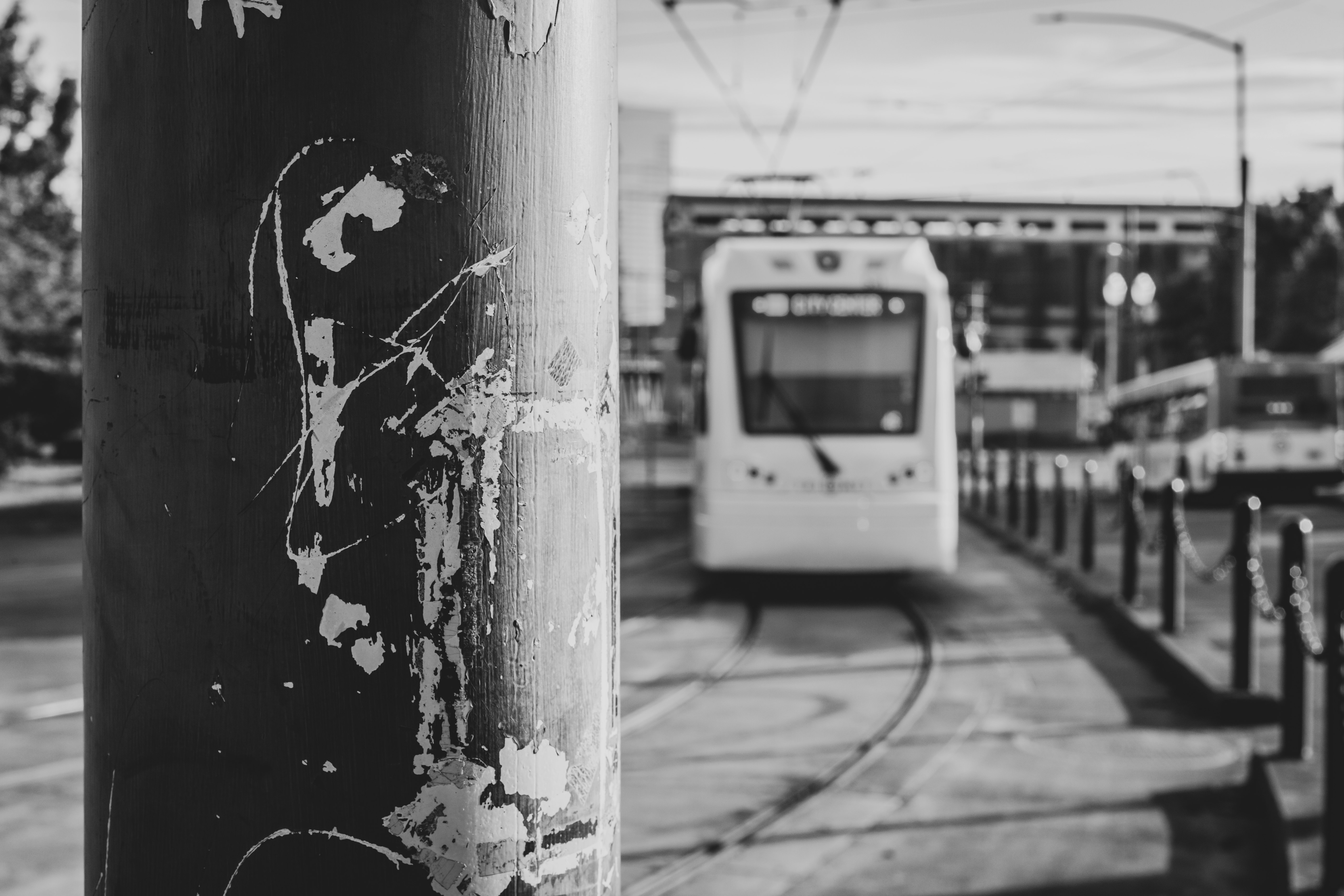 grayscale photo of a car parked beside a wall